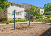 Thumbnail 44 of 57 - a swing set in front of an apartment building