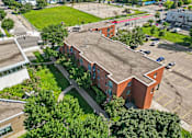 Thumbnail 14 of 25 - an aerial view of a brick building with a large roof