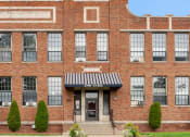 Thumbnail 30 of 31 - a large brick building with a flag on top of it