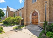 Thumbnail 40 of 45 - the front of a brick church with wooden doors and steps