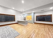 Thumbnail 22 of 24 - the living room has a wood floor and a large screen tv