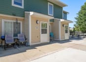 Thumbnail 14 of 27 - the front porch of a house with a patio and chairs