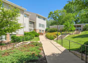 Thumbnail 43 of 57 - a sidewalk in front of a building with stairs and trees