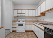 Thumbnail 2 of 27 - a kitchen with white cabinets and a stove and a sink
