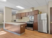 Thumbnail 48 of 51 - a kitchen with stainless steel appliances and wooden cabinets