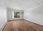 Thumbnail 11 of 23 - the living room of an empty house with wood floors and a window