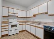 Thumbnail 1 of 27 - a kitchen with white cabinets and a stove and a sink
