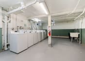 Thumbnail 21 of 27 - a large white room with white washing machines and a red fire hydrant