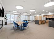 Thumbnail 20 of 26 - a dining room with tables and chairs in a large room with a ceiling full of