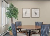 Thumbnail 29 of 51 - a dining room with a table and chairs and two pictures of birds on the wall