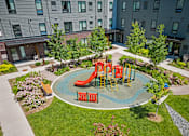 Thumbnail 40 of 53 - a playground in the middle of a park in a courtyard