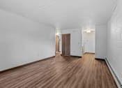 Thumbnail 10 of 23 - the living room and hallway of an empty house with wood floors and white walls