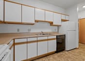 Thumbnail 3 of 27 - Photo of kitchen cabinets, sink, dishwasher and refrigerator