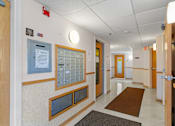 Thumbnail 7 of 25 - a hallway in a hospital with doors and walls and rugs