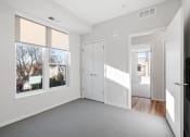 Thumbnail 12 of 45 - a living room with a large window and a door