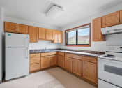 Thumbnail 22 of 43 - a kitchen with wooden cabinets and appliances and a window
