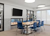 Thumbnail 18 of 26 - The community room with table, chairs, TV and a fireplace