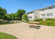Thumbnail 40 of 57 - a picnic table on a sidewalk in front of an apartment building