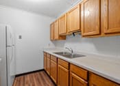 Thumbnail 8 of 23 - a kitchen with wooden cabinets and a sink and a refrigerator