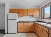 Thumbnail 21 of 43 - a kitchen with wooden cabinets and a white refrigerator