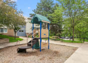 Thumbnail 39 of 57 - a playground with a playset and a slide in a park