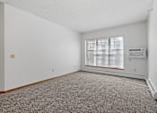 Thumbnail 5 of 27 - Photo of living room with large windows and wall mounted air conditioner