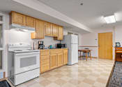 Thumbnail 8 of 25 - a kitchen with white appliances and wooden cabinets