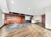 Thumbnail 11 of 36 - A room with wooden floors and a blue rug in the middle.