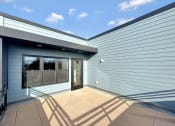 Thumbnail 12 of 36 - the front of a blue building with a glass door