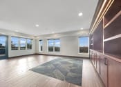 Thumbnail 10 of 36 - an empty living room with wood flooring and large windows