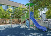 Thumbnail 9 of 27 - a playground with a blue slide and a green umbrella
