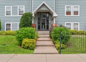 Thumbnail 31 of 31 - the front of a blue house with a sidewalk in front of it