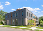 Thumbnail 33 of 45 - a three story building with a street in front of it