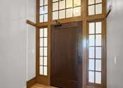 Thumbnail 10 of 24 - the front door of a house with a hardwood floor and a window
