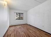 Thumbnail 15 of 23 - the living room has wood floors and white walls and a window