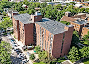 Thumbnail 40 of 55 - an aerial view of a brick building with a gray roof