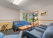 Thumbnail 11 of 25 - a living room with couches and chairs and a table
