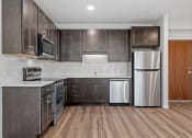Thumbnail 1 of 45 - a kitchen with stainless steel appliances and wooden cabinets