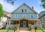 Thumbnail 34 of 67 - the front of a blue house with a porch and stairs