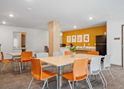 Thumbnail 34 of 53 - a dining room with orange chairs and a table