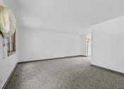 Thumbnail 17 of 43 - an empty room with carpet and white walls