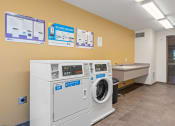 Thumbnail 14 of 52 - a laundry room with a washing machine and a sink