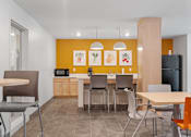 Thumbnail 31 of 53 - a dining room and kitchen with a table and chairs
