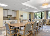 Thumbnail 12 of 25 - a conference room with a table and chairs and a kitchen