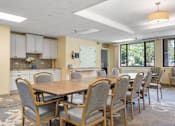 Thumbnail 24 of 25 - a conference room with a table and chairs and a kitchen