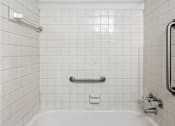 Thumbnail 17 of 23 - a white tub in a bathroom with white tiles