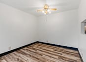 Thumbnail 6 of 40 - the living room of a home with a wood floor and a ceiling fan