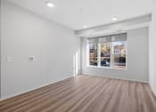 Thumbnail 13 of 45 - a living room with white walls and a window