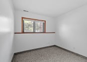 Thumbnail 14 of 43 - an empty room with a window in the corner