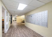 Thumbnail 6 of 25 - a long hallway with a calendar on the wall